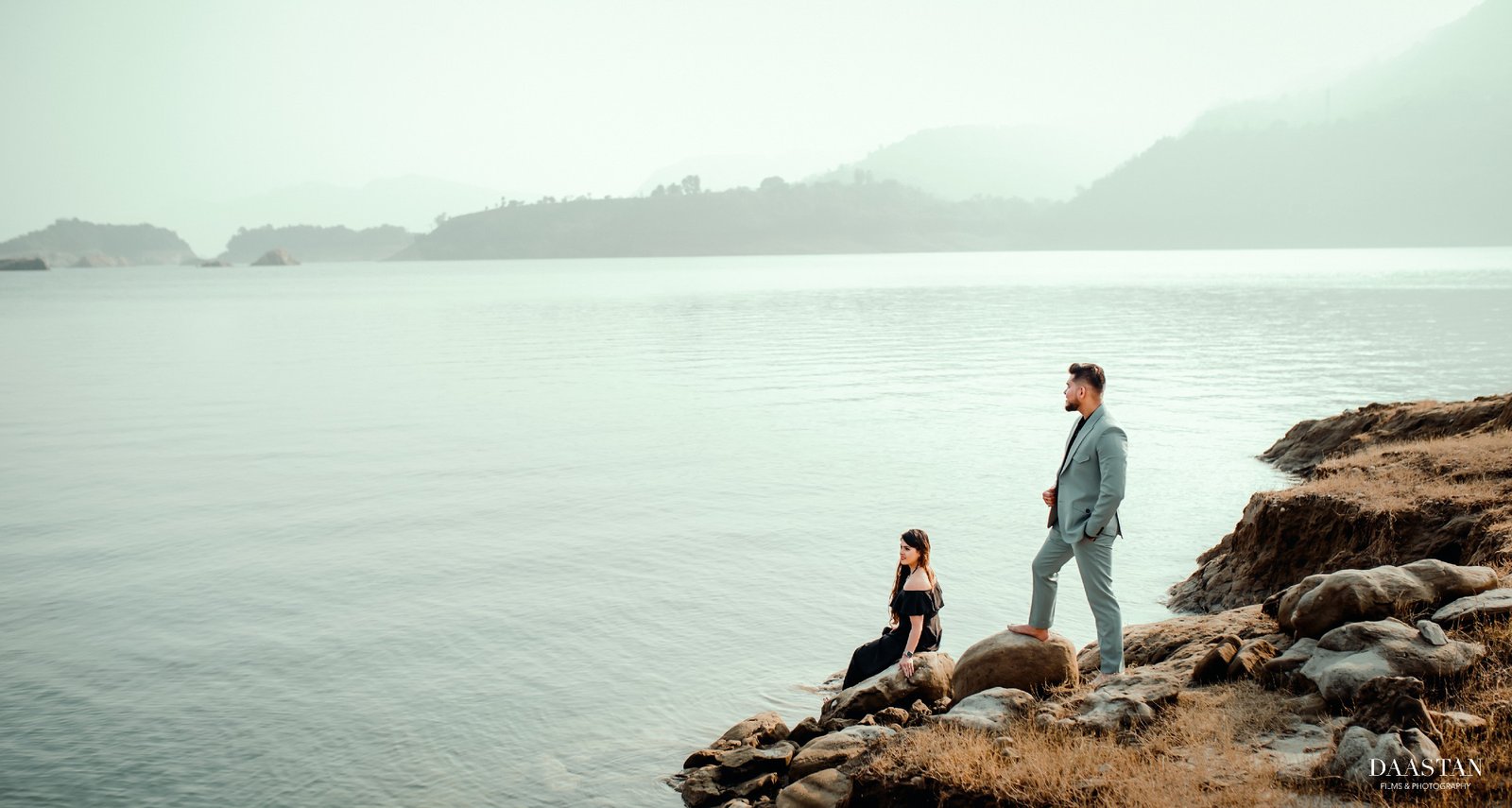 Couple silhouette on beach rocks during pre-wedding shoot, cinematic Indian couple photography