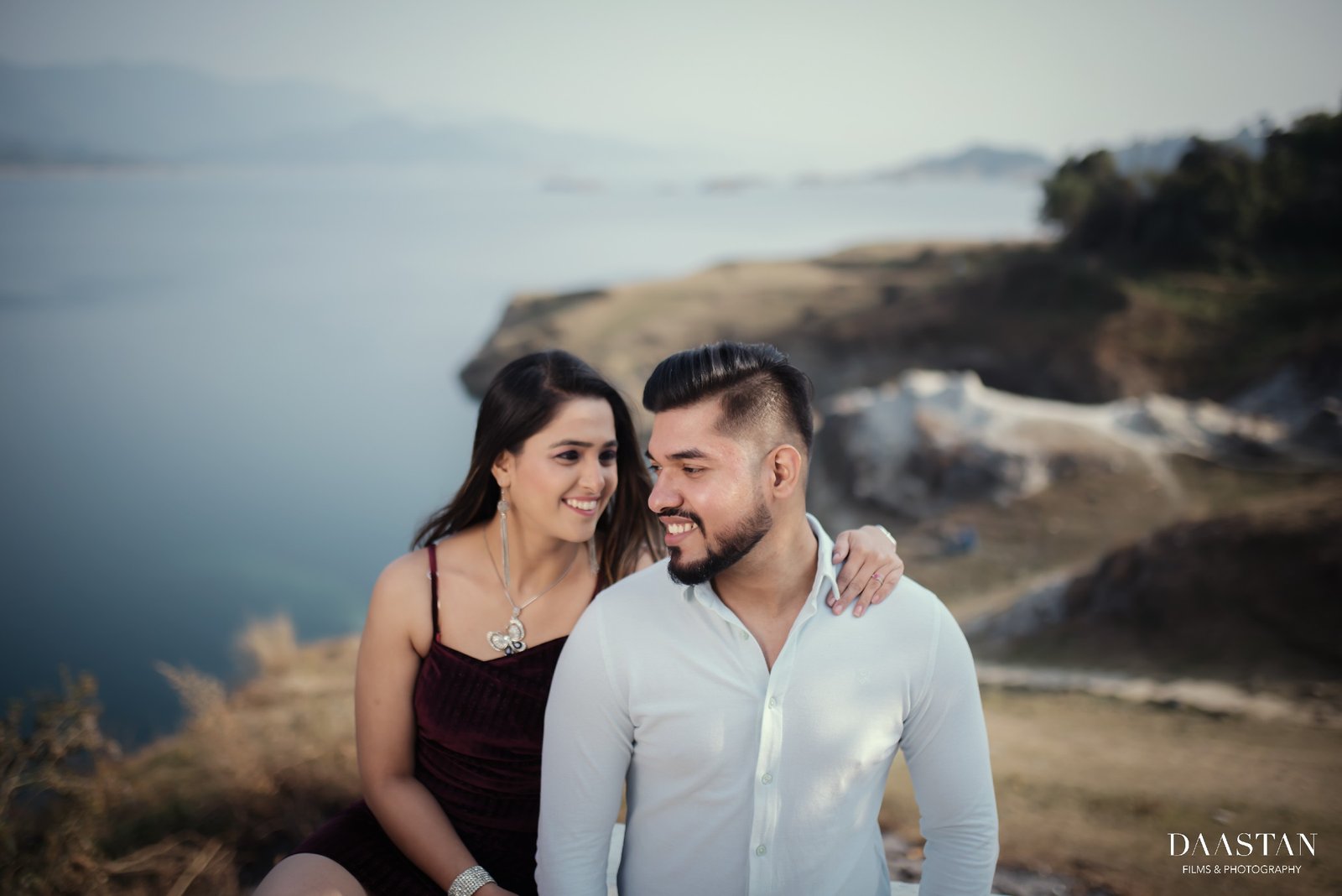 Couple sitting on beach during outdoor pre-wedding shoot, natural Indian couple photography