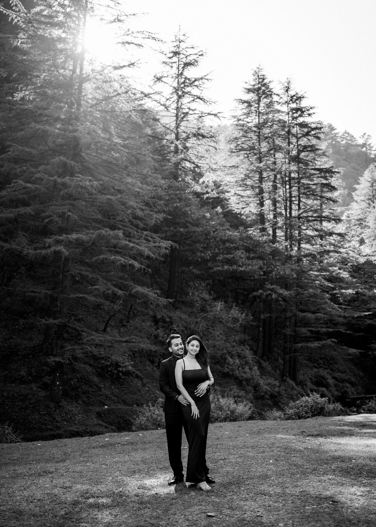 Cinematic black and white forest pre-wedding portrait of couple, Indian photography