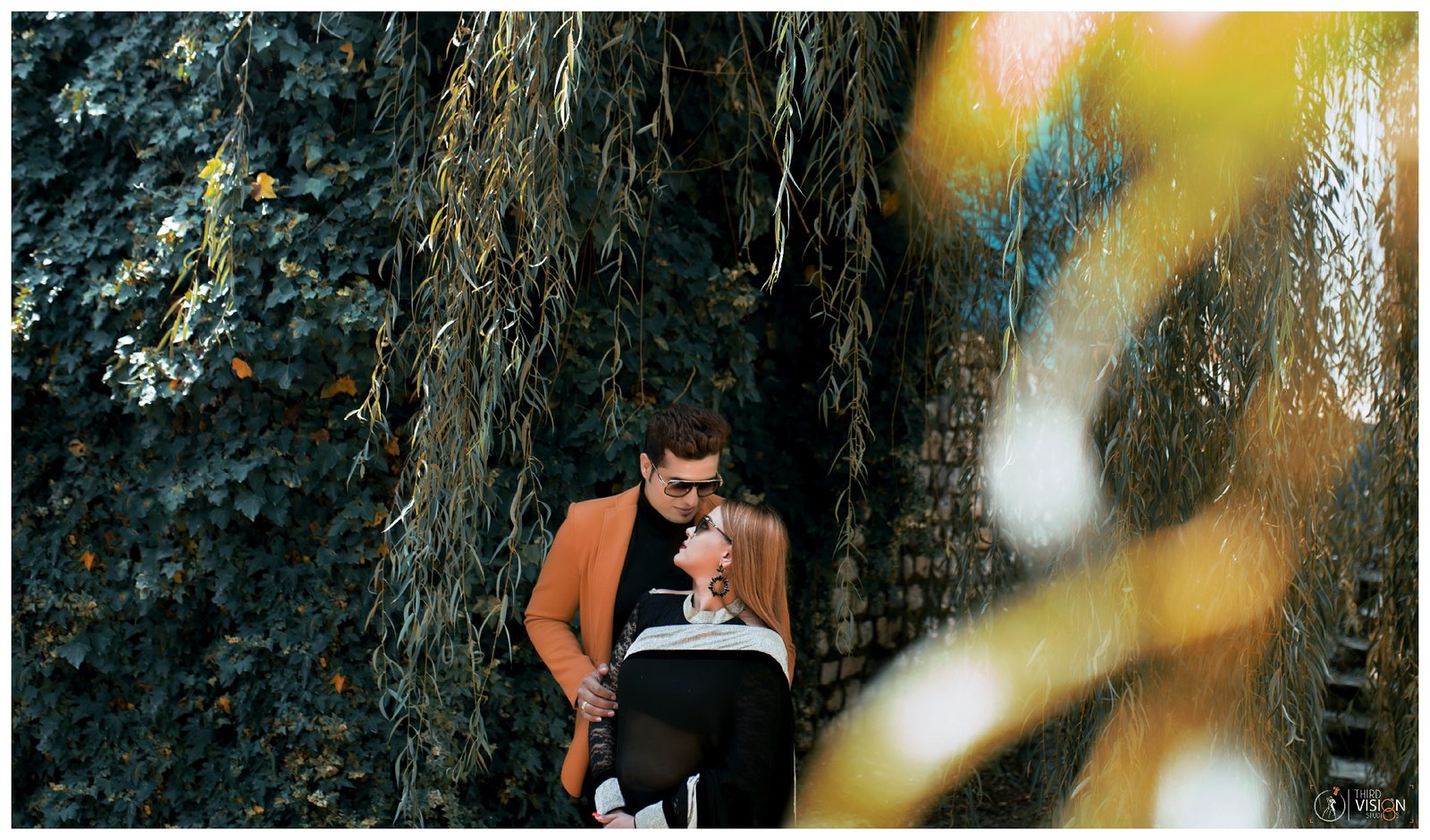 Couple with bokeh forest background during outdoor pre-wedding shoot, Indian photography