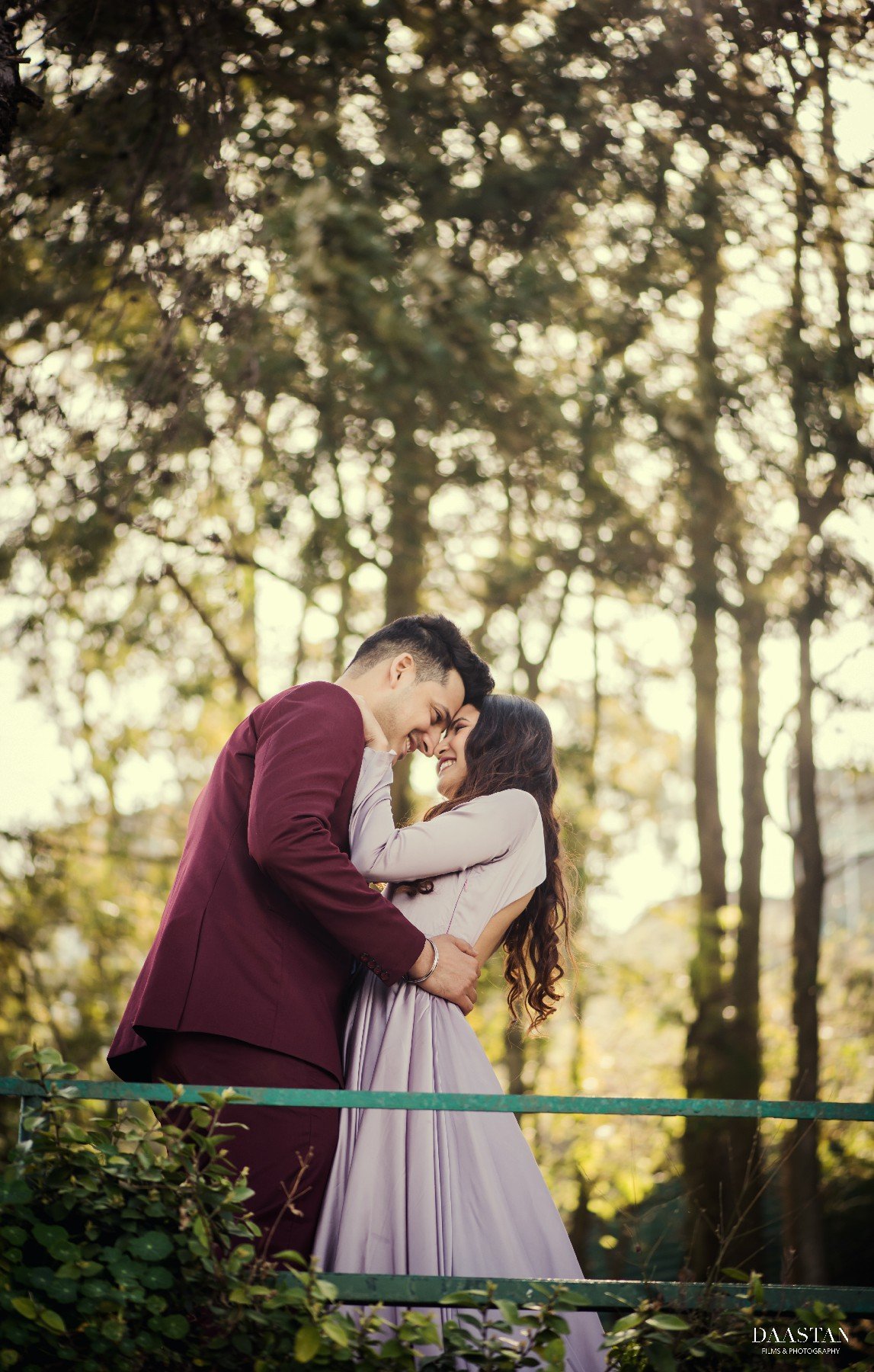 Couple embracing in forest during outdoor pre-wedding shoot, Indian couple photography