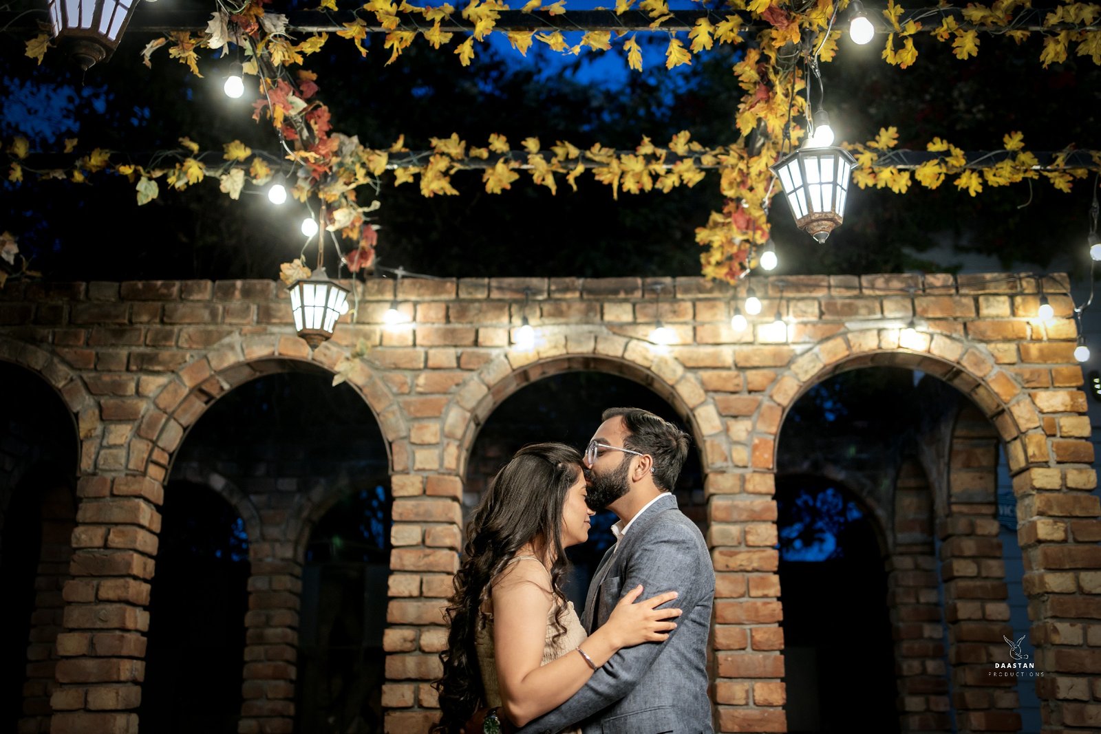 Couple at heritage arch at night during pre-wedding shoot, cinematic Indian couple photography