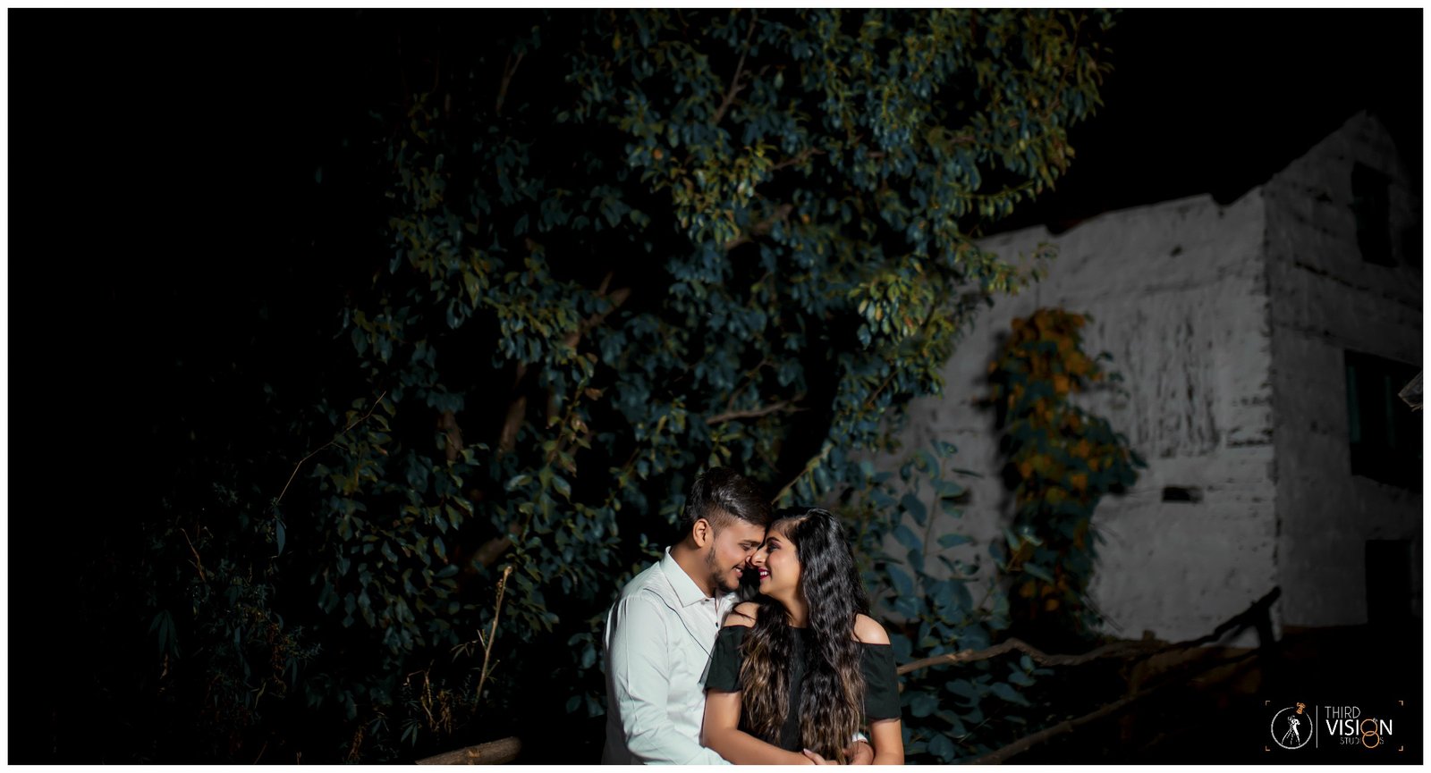 Couple at dark heritage arch location during pre-wedding shoot, cinematic Indian photography