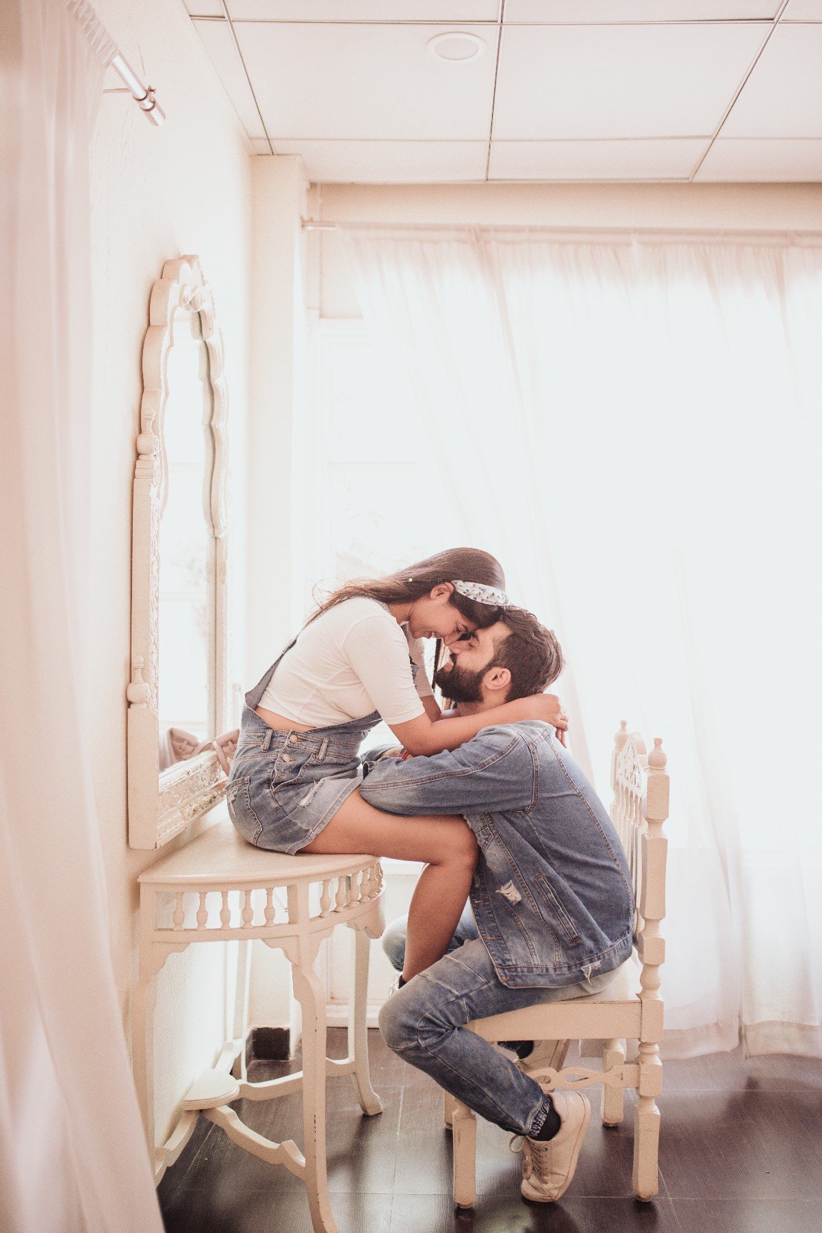 Fun candid indoor pre-wedding portrait of couple, joyful Indian couple photography