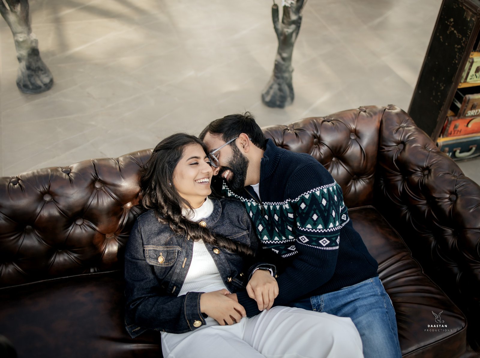 Candid laughing couple during indoor pre-wedding shoot, fun couple photography India
