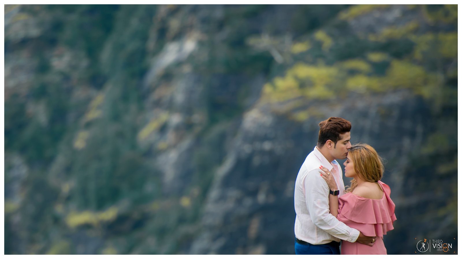 Couple in lush mountain greenery during pre-wedding shoot, outdoor Indian couple photography