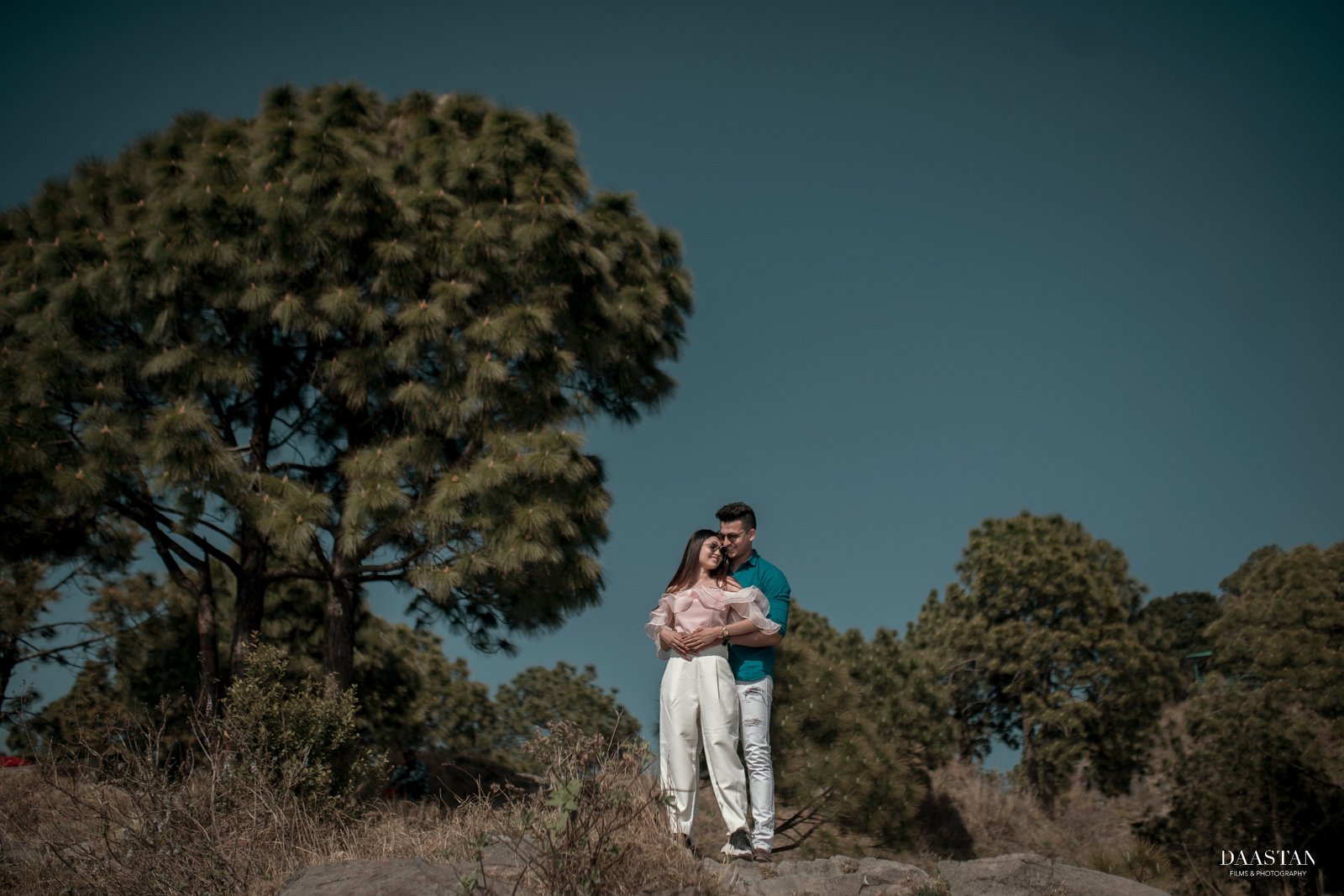 Couple in mountain meadow during outdoor pre-wedding shoot, Indian couple photography