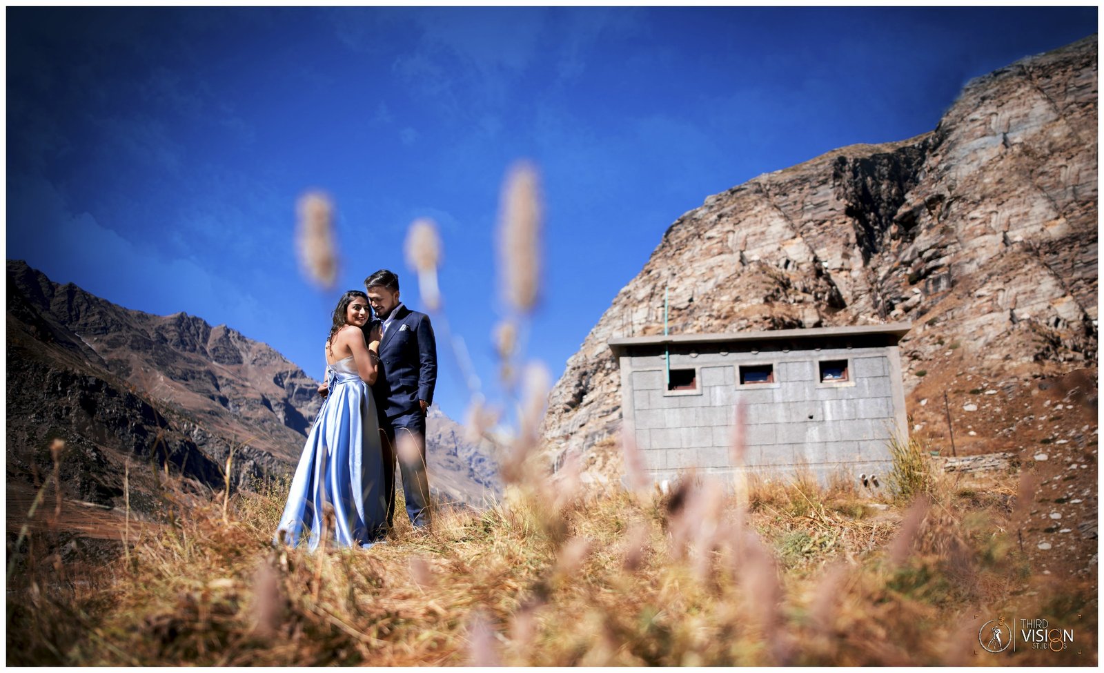Couple in mountain meadow during pre-wedding shoot, outdoor Indian couple photography