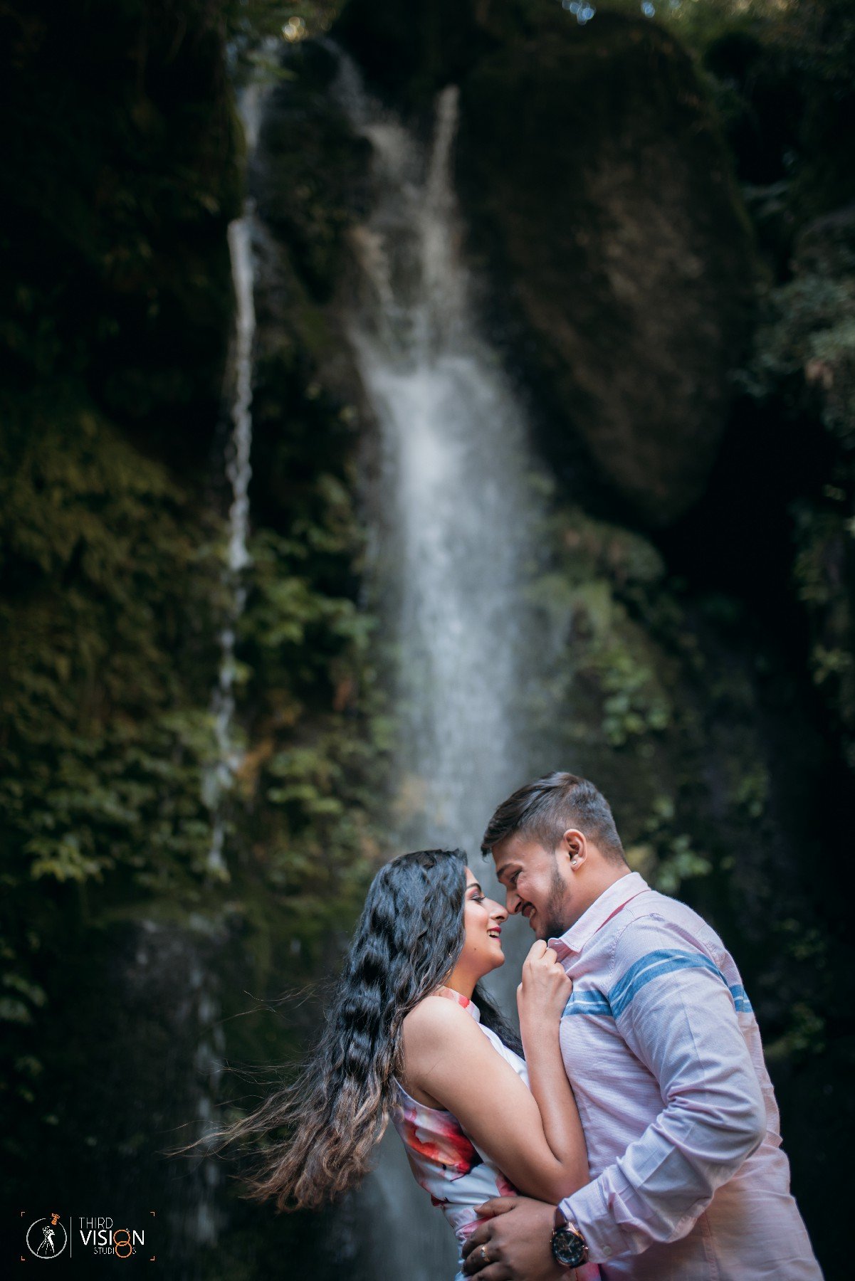 Couple portrait near mountain waterfall during pre-wedding shoot, Indian destination photography