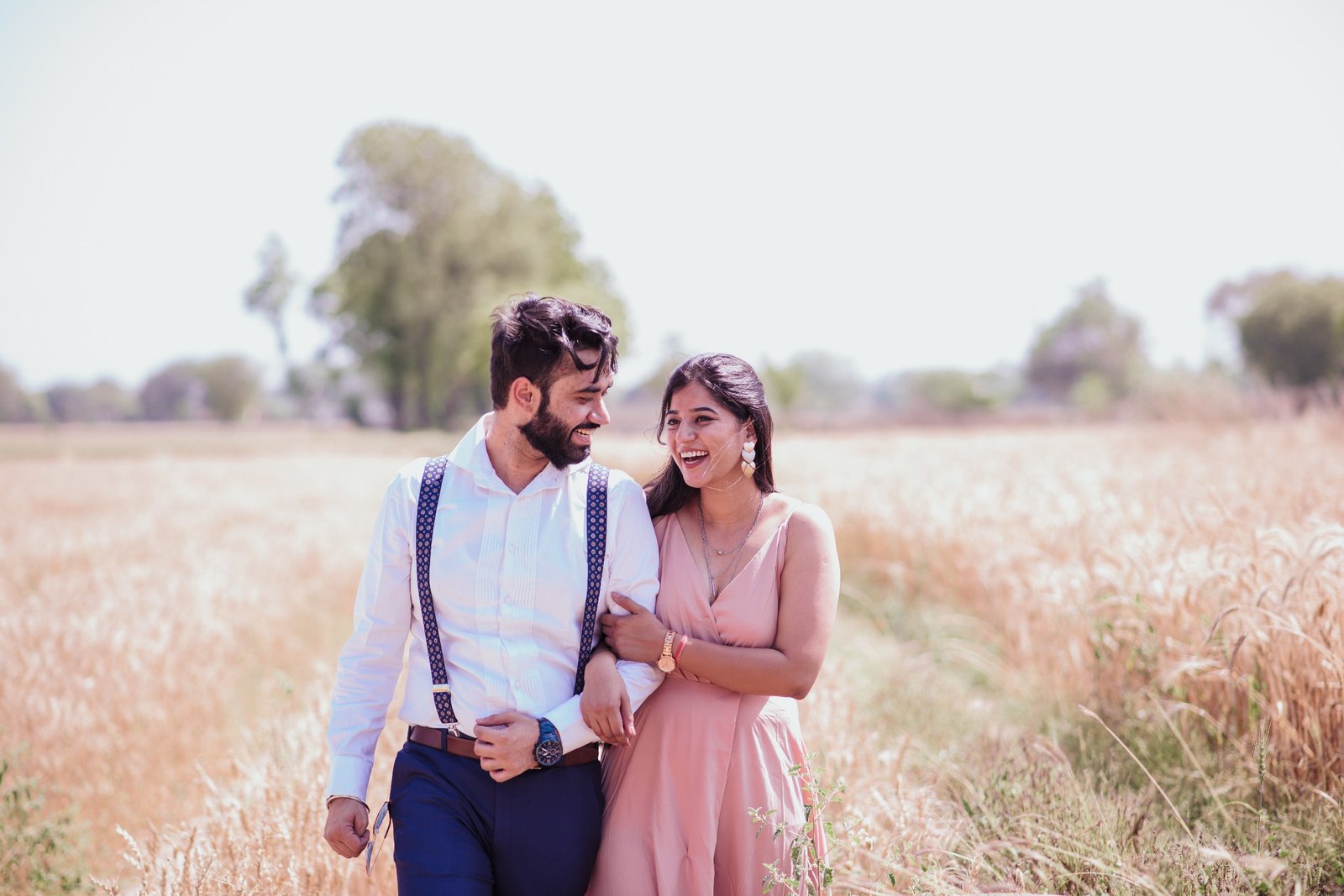 Couple in mustard field during outdoor pre-wedding shoot, Indian couple photography