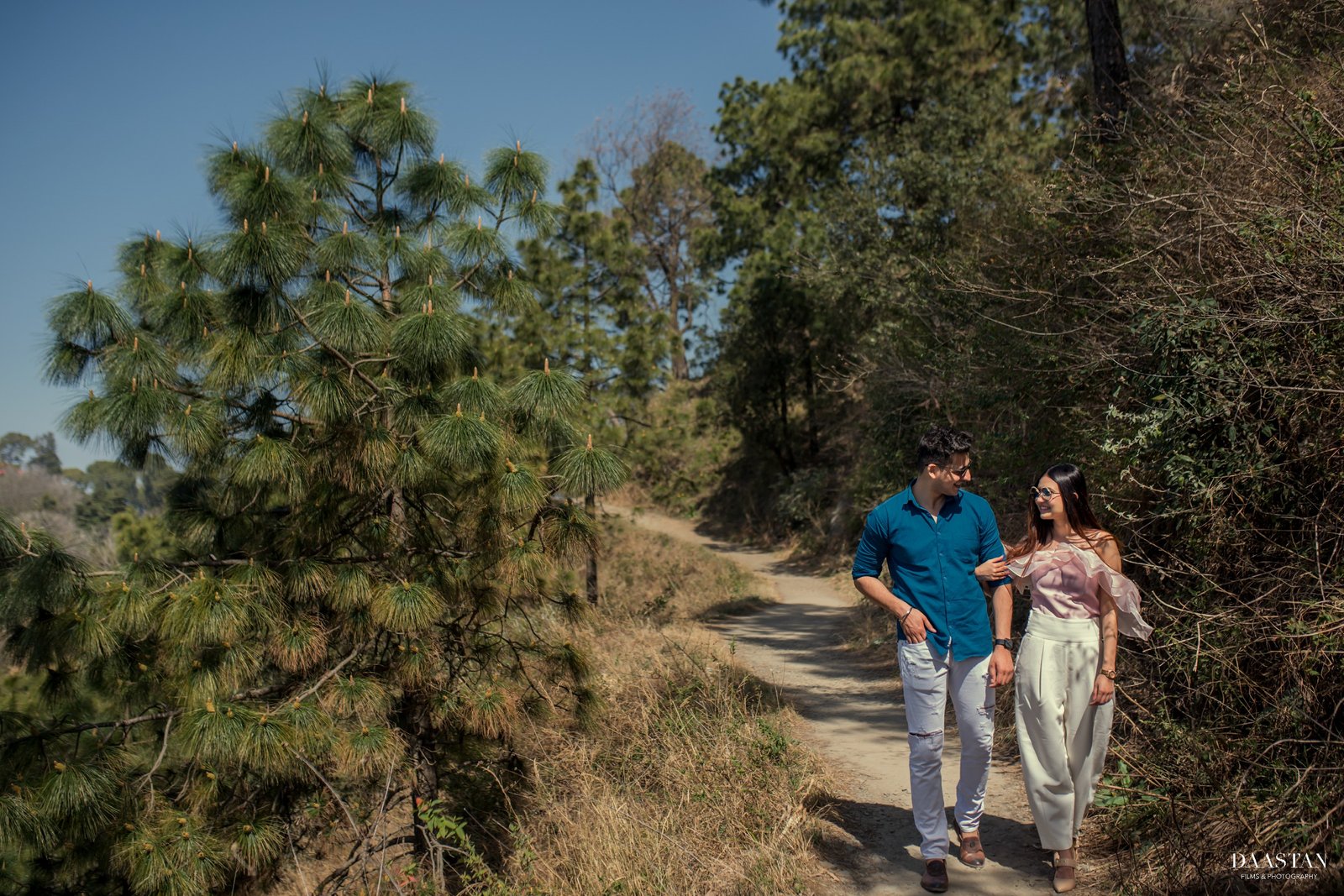 Couple on nature trail during outdoor pre-wedding shoot, candid Indian couple photography