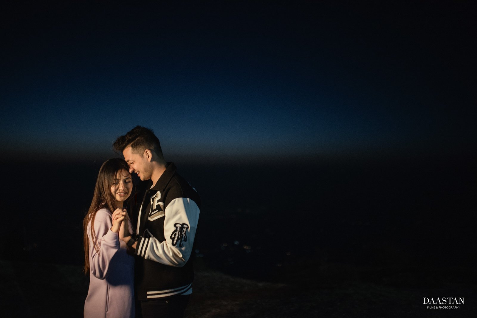 Couple at night in pine forest during pre-wedding shoot, moody Indian couple photography