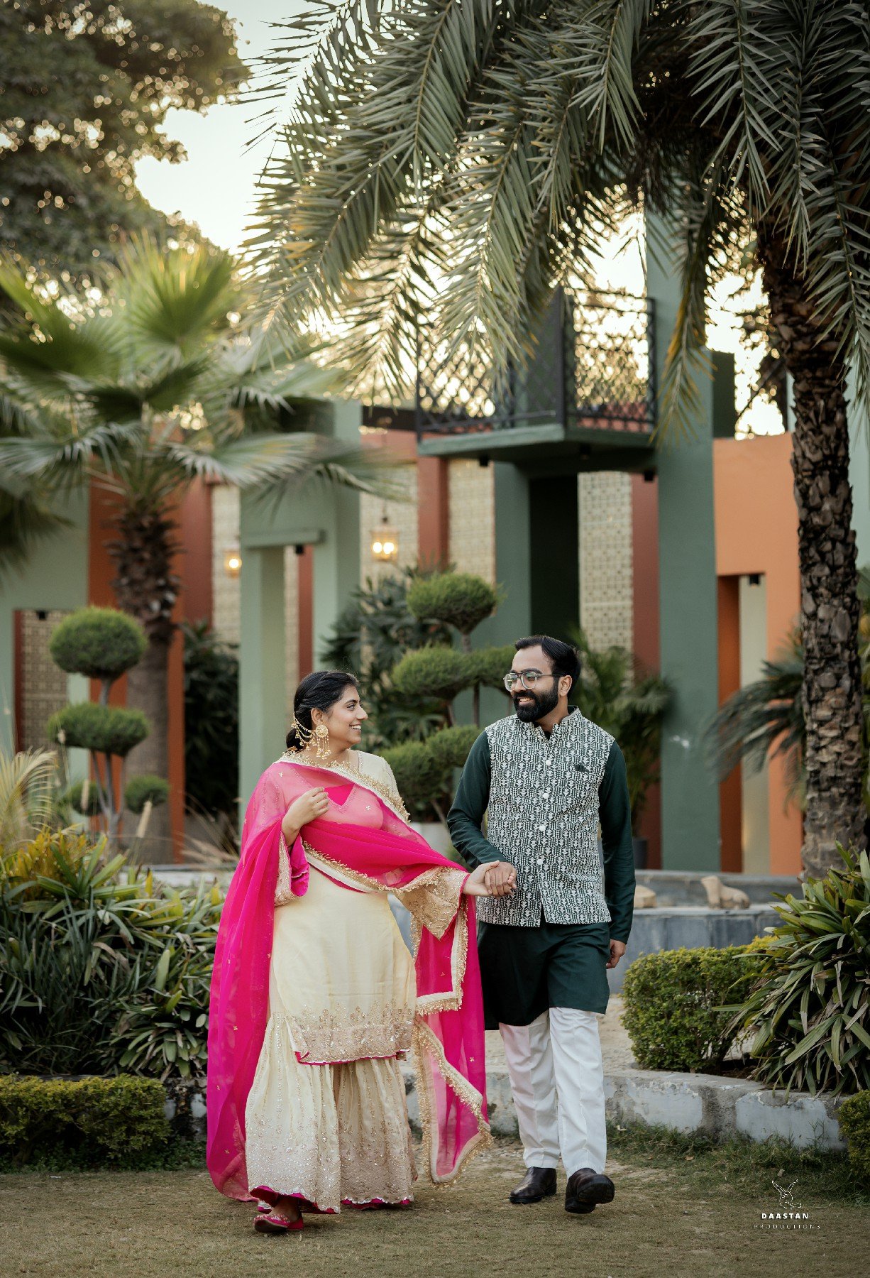 Couple in colourful outfits in garden during outdoor pre-wedding shoot, Indian photography