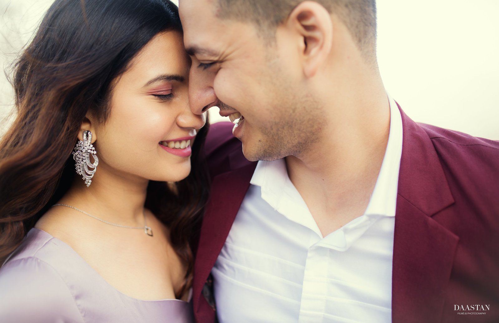 Smiling romantic outdoor pre-wedding portrait of couple, joyful Indian couple photography