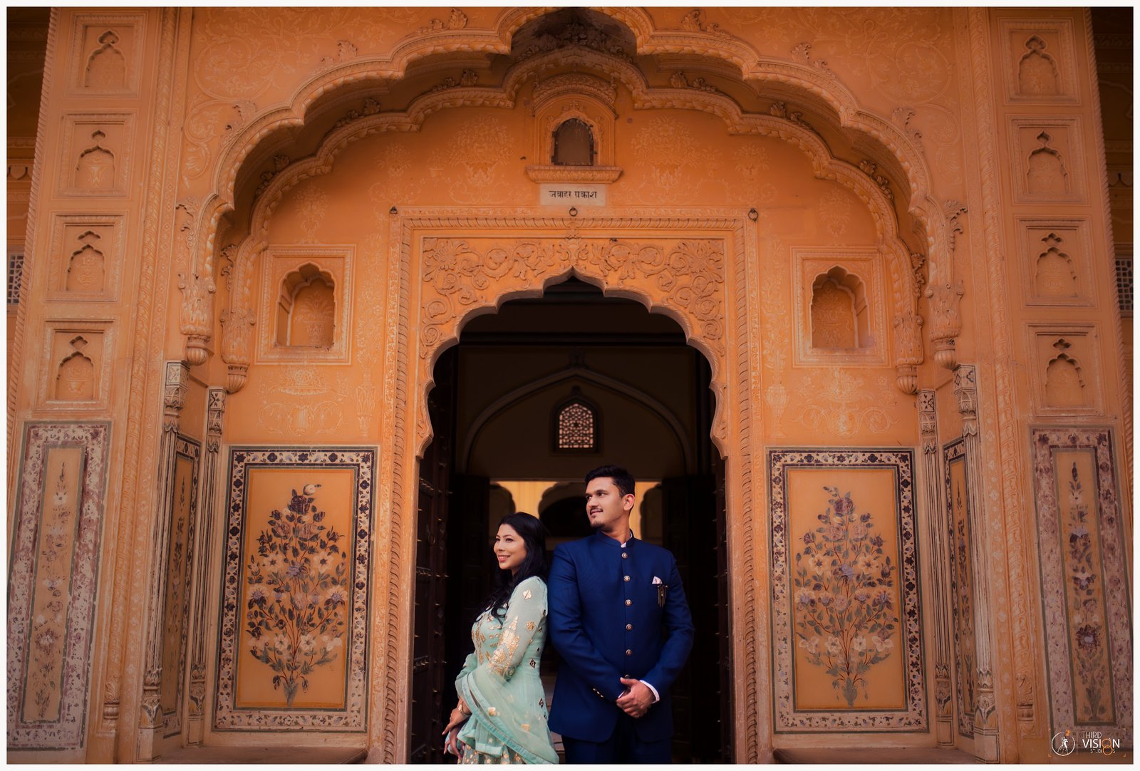 Couple at Rajasthan fort arch during pre-wedding shoot, destination Indian couple photography