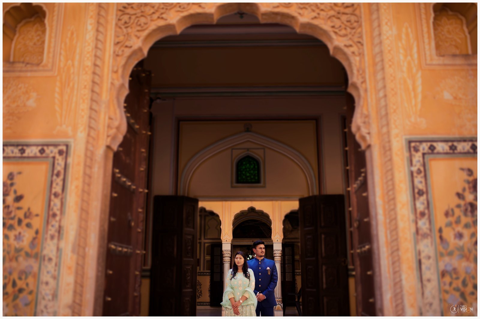 Couple posing under Rajasthan heritage arch during pre-wedding shoot, Indian destination photography
