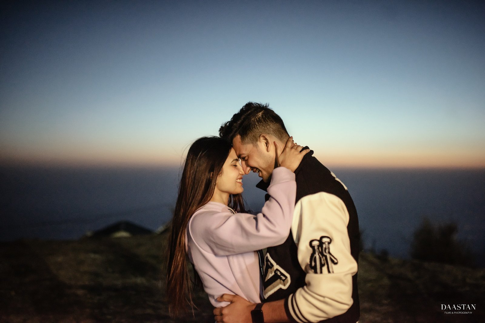 Couple embracing in golden sunset forest during pre-wedding shoot, Indian couple photography