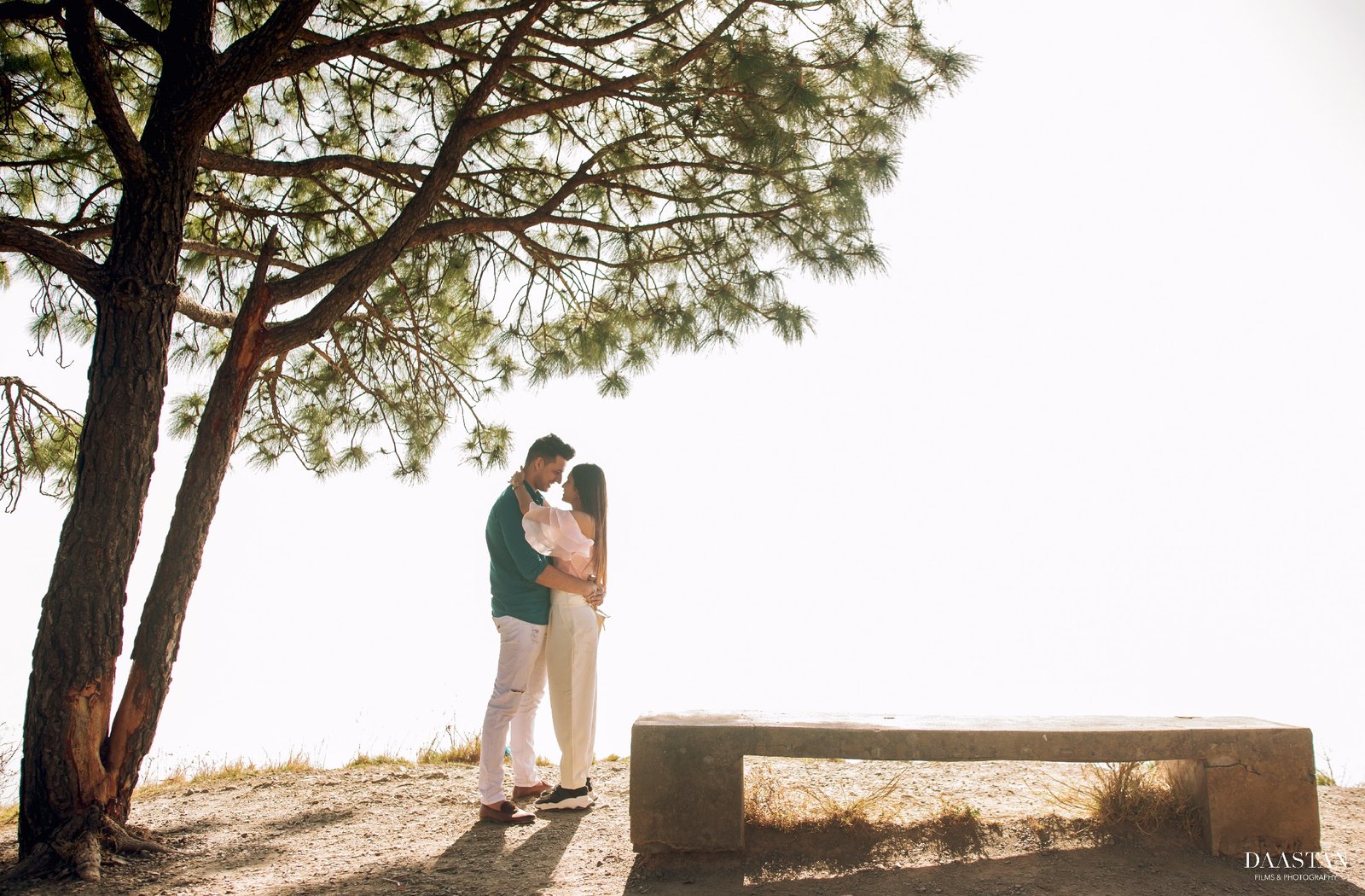 Couple silhouette against tree during outdoor pre-wedding shoot, cinematic Indian photography