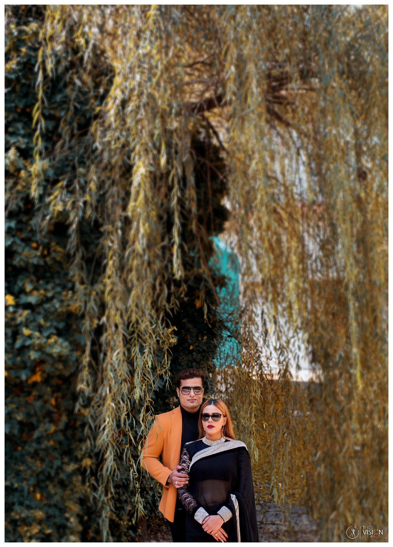 Couple near waterfall in forest during outdoor pre-wedding shoot, Indian couple photography