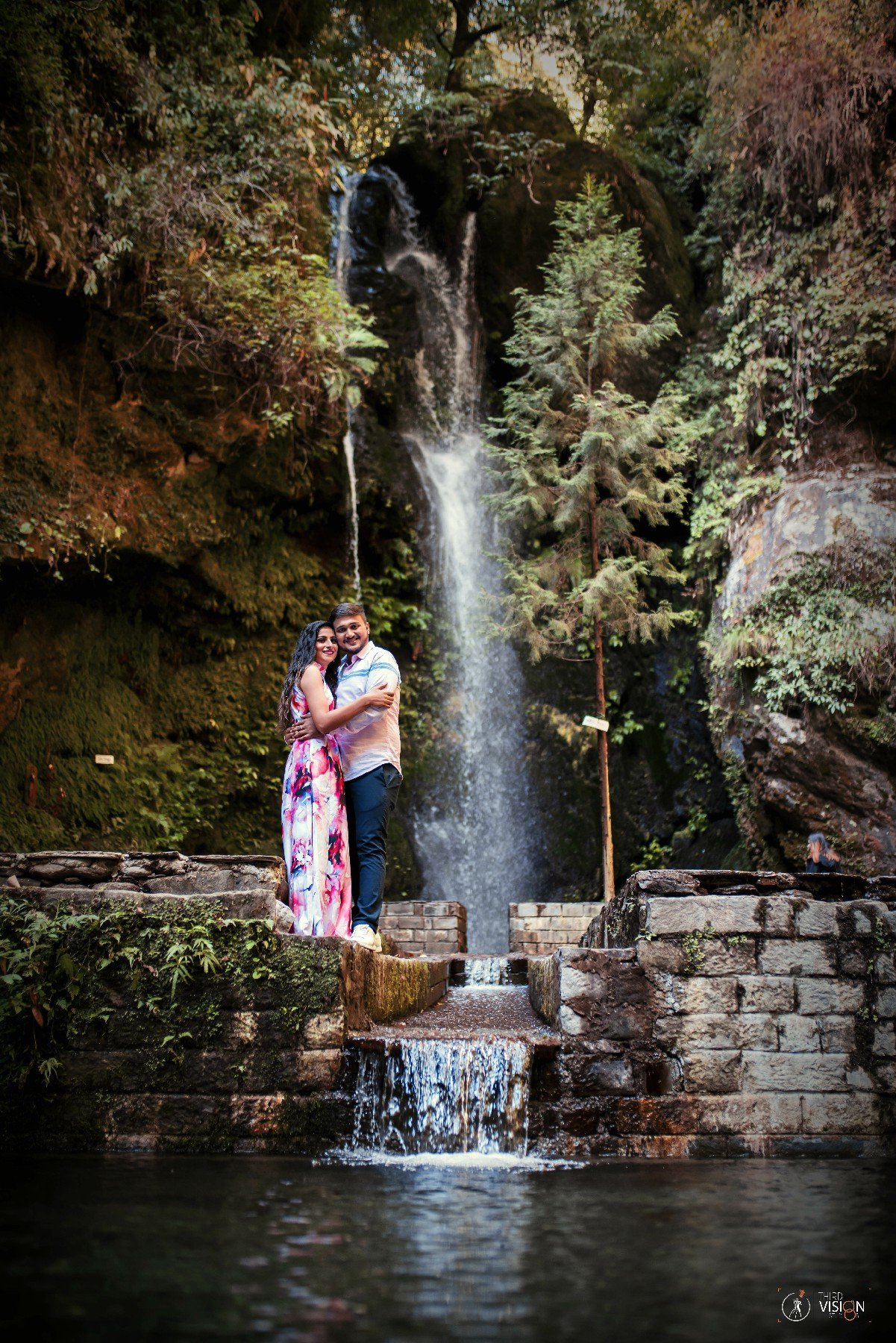 Couple near scenic waterfall during outdoor pre-wedding shoot, Indian couple photography