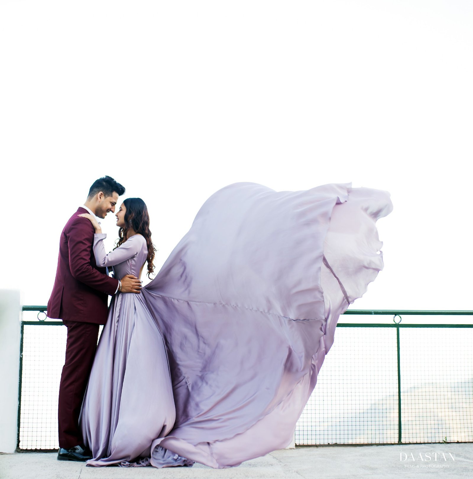 Couple in windy outdoor setting with flowing gown during pre-wedding shoot, Indian photography